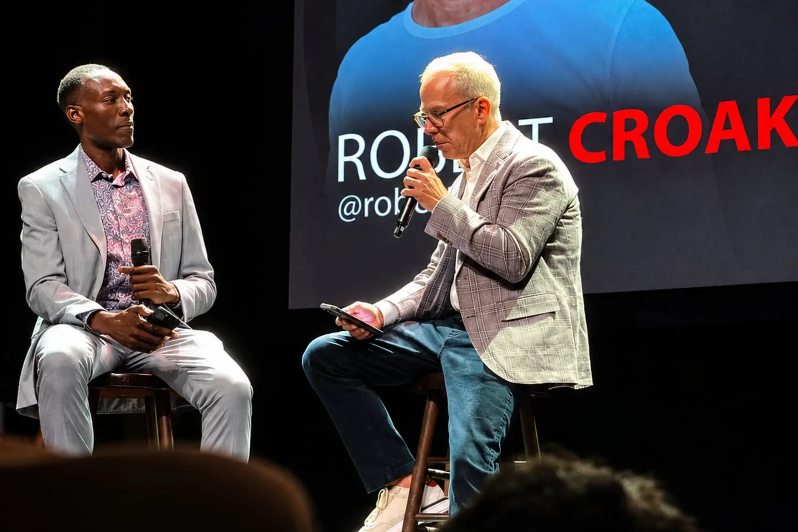 Two speakers in a fireside conversation on stage at a previous event