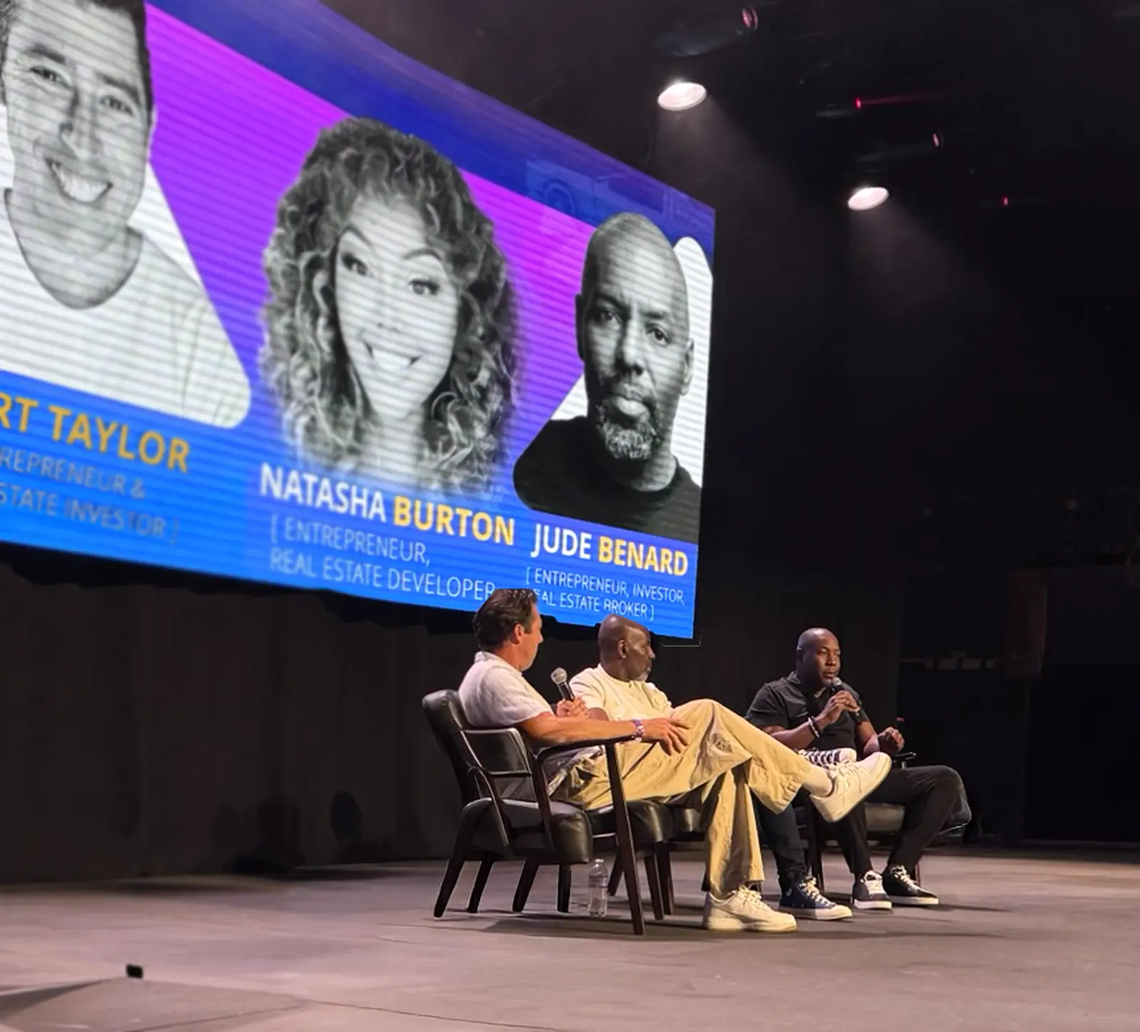 A panel of speakers on stage at a previous event
